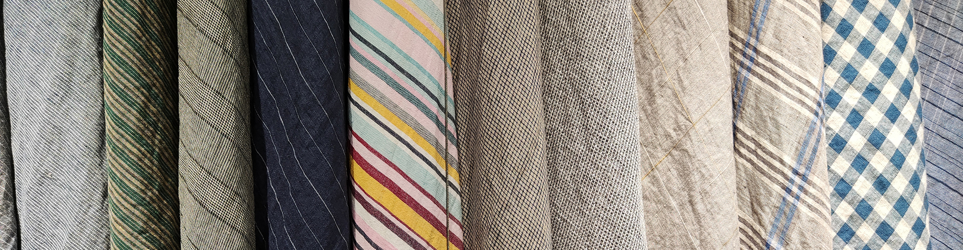 A row of yarn dyed linen fabrics in stripes, checks and solids